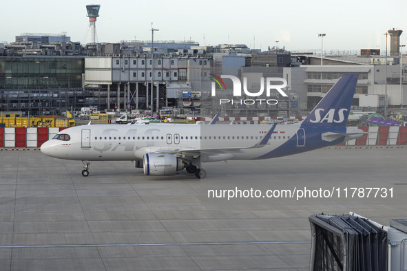 SAS Connect Airbus A320neo aircraft spotted taxiing at London Heathrow Airport LHR in front of the terminal and the air control tower. The m...