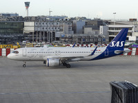 SAS Connect Airbus A320neo aircraft spotted taxiing at London Heathrow Airport LHR in front of the terminal and the air control tower. The m...