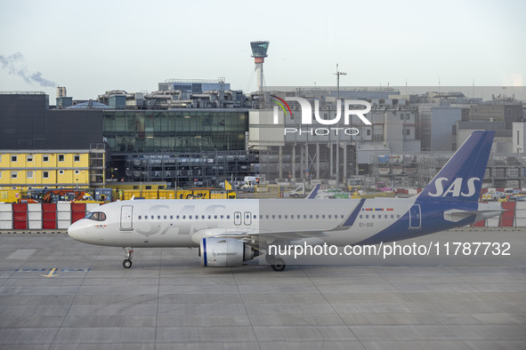 SAS Connect Airbus A320neo aircraft spotted taxiing at London Heathrow Airport LHR in front of the terminal and the air control tower. The m...