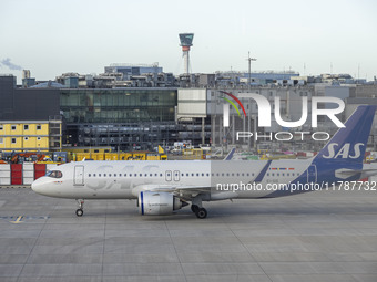 SAS Connect Airbus A320neo aircraft spotted taxiing at London Heathrow Airport LHR in front of the terminal and the air control tower. The m...