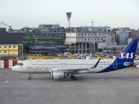 SAS Connect Airbus A320neo aircraft spotted taxiing at London Heathrow Airport LHR in front of the terminal and the air control tower. The m...