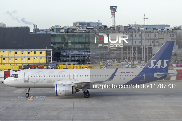 SAS Connect Airbus A320neo aircraft spotted taxiing at London Heathrow Airport LHR in front of the terminal and the air control tower. The m...