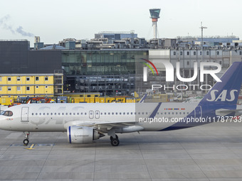 SAS Connect Airbus A320neo aircraft spotted taxiing at London Heathrow Airport LHR in front of the terminal and the air control tower. The m...