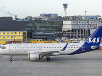 SAS Connect Airbus A320neo aircraft spotted taxiing at London Heathrow Airport LHR in front of the terminal and the air control tower. The m...