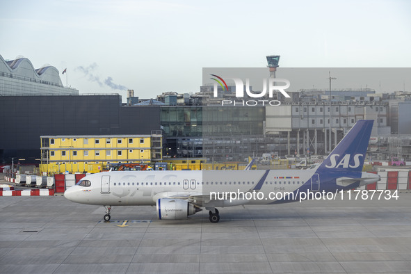 SAS Connect Airbus A320neo aircraft spotted taxiing at London Heathrow Airport LHR in front of the terminal and the air control tower. The m...