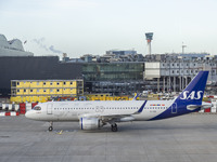 SAS Connect Airbus A320neo aircraft spotted taxiing at London Heathrow Airport LHR in front of the terminal and the air control tower. The m...