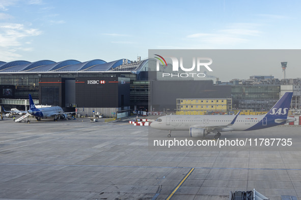 SAS Connect Airbus A320neo aircraft spotted taxiing at London Heathrow Airport LHR in front of the terminal and the air control tower. The m...