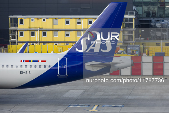 SAS Connect Airbus A320neo aircraft spotted taxiing at London Heathrow Airport LHR in front of the terminal and the air control tower. The m...