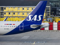 SAS Connect Airbus A320neo aircraft spotted taxiing at London Heathrow Airport LHR in front of the terminal and the air control tower. The m...