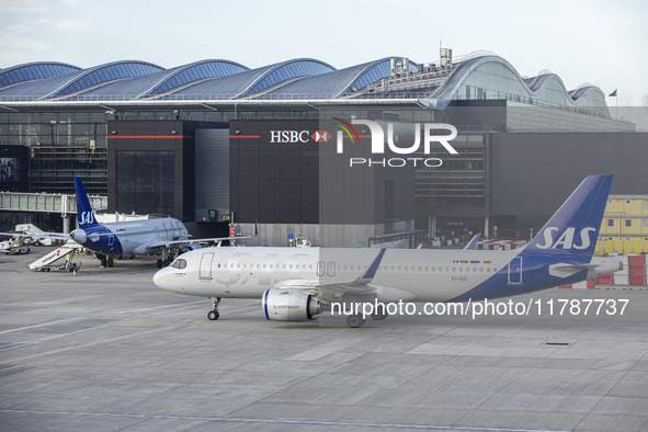 SAS Connect Airbus A320neo aircraft spotted taxiing at London Heathrow Airport LHR in front of the terminal and the air control tower. The m...