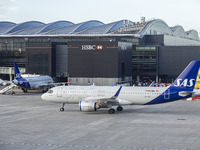 SAS Connect Airbus A320neo aircraft spotted taxiing at London Heathrow Airport LHR in front of the terminal and the air control tower. The m...