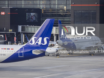 SAS Connect Airbus A320neo aircraft spotted taxiing at London Heathrow Airport LHR in front of the terminal and the air control tower. The m...