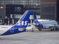 SAS Connect Airbus A320neo aircraft spotted taxiing at London Heathrow Airport LHR in front of the terminal and the air control tower. The m...