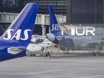 SAS Connect Airbus A320neo aircraft spotted taxiing at London Heathrow Airport LHR in front of the terminal and the air control tower. The m...