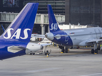 SAS Connect Airbus A320neo aircraft spotted taxiing at London Heathrow Airport LHR in front of the terminal and the air control tower. The m...