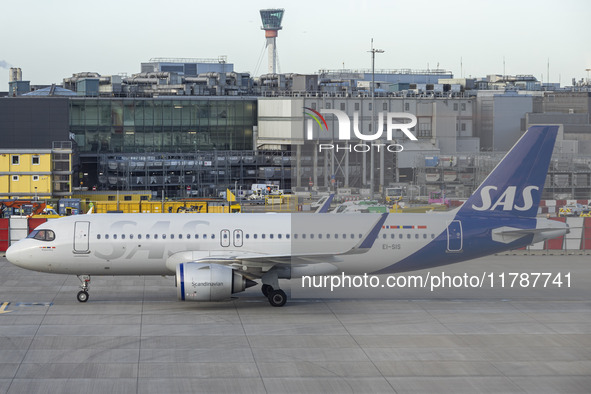 SAS Connect Airbus A320neo aircraft spotted taxiing at London Heathrow Airport LHR in front of the terminal and the air control tower. The m...