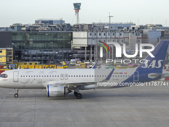 SAS Connect Airbus A320neo aircraft spotted taxiing at London Heathrow Airport LHR in front of the terminal and the air control tower. The m...