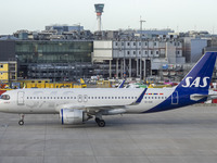 SAS Connect Airbus A320neo aircraft spotted taxiing at London Heathrow Airport LHR in front of the terminal and the air control tower. The m...