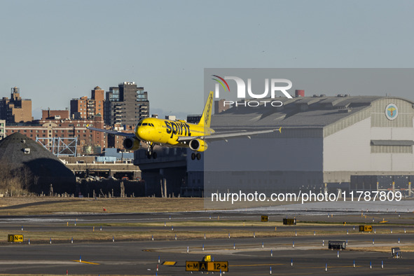 Spirit Airlines Airbus A320 aircraft spotted flying, landing and taxiing in LaGuardia airport. The iconic yellow A320-200 passenger airplane...