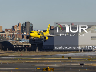 Spirit Airlines Airbus A320 aircraft spotted flying, landing and taxiing in LaGuardia airport. The iconic yellow A320-200 passenger airplane...