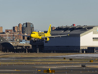 Spirit Airlines Airbus A320 aircraft spotted flying, landing and taxiing in LaGuardia airport. The iconic yellow A320-200 passenger airplane...