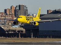 Spirit Airlines Airbus A320 aircraft spotted flying, landing and taxiing in LaGuardia airport. The iconic yellow A320-200 passenger airplane...