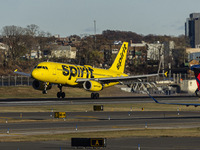 Spirit Airlines Airbus A320 aircraft spotted flying, landing and taxiing in LaGuardia airport. The iconic yellow A320-200 passenger airplane...