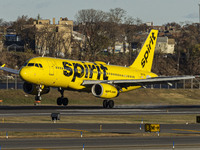 Spirit Airlines Airbus A320 aircraft spotted flying, landing and taxiing in LaGuardia airport. The iconic yellow A320-200 passenger airplane...