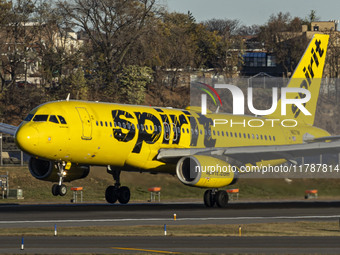 Spirit Airlines Airbus A320 aircraft spotted flying, landing and taxiing in LaGuardia airport. The iconic yellow A320-200 passenger airplane...