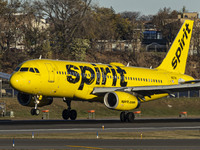 Spirit Airlines Airbus A320 aircraft spotted flying, landing and taxiing in LaGuardia airport. The iconic yellow A320-200 passenger airplane...