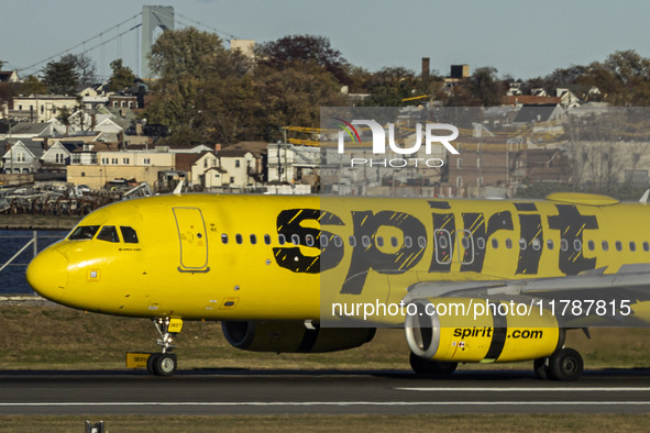 Spirit Airlines Airbus A320 aircraft spotted flying, landing and taxiing in LaGuardia airport. The iconic yellow A320-200 passenger airplane...