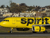 Spirit Airlines Airbus A320 aircraft spotted flying, landing and taxiing in LaGuardia airport. The iconic yellow A320-200 passenger airplane...