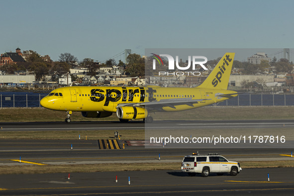 Spirit Airlines Airbus A320 aircraft spotted flying, landing and taxiing in LaGuardia airport. The iconic yellow A320-200 passenger airplane...