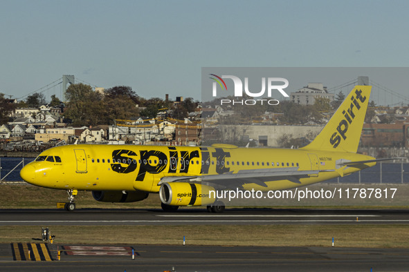 Spirit Airlines Airbus A320 aircraft spotted flying, landing and taxiing in LaGuardia airport. The iconic yellow A320-200 passenger airplane...