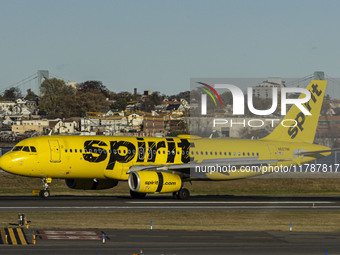 Spirit Airlines Airbus A320 aircraft spotted flying, landing and taxiing in LaGuardia airport. The iconic yellow A320-200 passenger airplane...