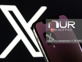 An editorial image features the X app icon, linked to Elon Musk, prominently displayed on an iPhone screen. The X logo is subtly visible in...