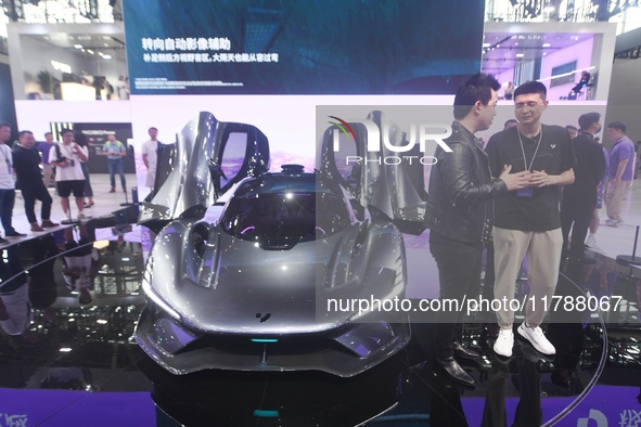 Visitors view the world's first AI-powered supercar, ROBO X, at the Guangzhou Auto Show in Guangzhou, China, on November 15, 2024. 