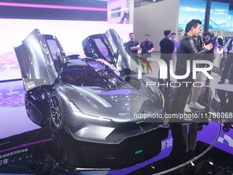 Visitors view the world's first AI-powered supercar, ROBO X, at the Guangzhou Auto Show in Guangzhou, China, on November 15, 2024. (