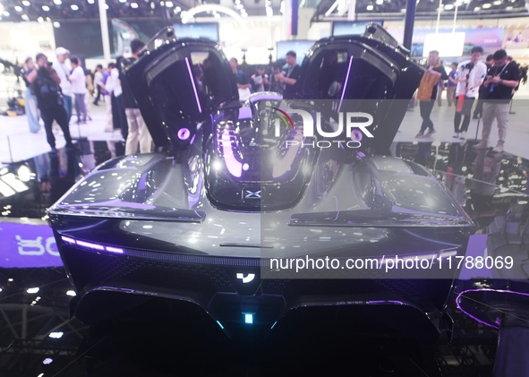 Visitors view the world's first AI-powered supercar, ROBO X, at the Guangzhou Auto Show in Guangzhou, China, on November 15, 2024. 