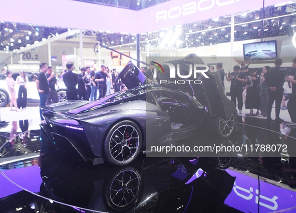 Visitors view the world's first AI-powered supercar, ROBO X, at the Guangzhou Auto Show in Guangzhou, China, on November 15, 2024. 