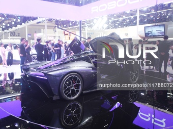 Visitors view the world's first AI-powered supercar, ROBO X, at the Guangzhou Auto Show in Guangzhou, China, on November 15, 2024. (