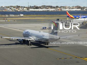 JetBlue Airbus A320-200 passenger aircraft spotted taxiing in LaGuardia airport LGA in New York City while a Southwest Boeing 737 is taxiing...