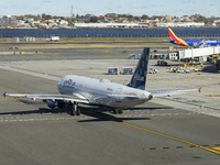 JetBlue Airbus A320-200 passenger aircraft spotted taxiing in LaGuardia airport LGA in New York City while a Southwest Boeing 737 is taxiing...