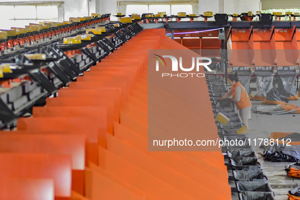 Workers sort parcels at an express logistics company in Qingzhou, China, on November 11, 2024. Monitoring data from the State Post Bureau sh...