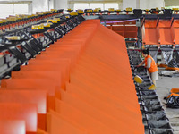 Workers sort parcels at an express logistics company in Qingzhou, China, on November 11, 2024. Monitoring data from the State Post Bureau sh...