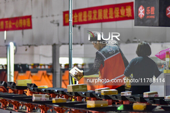 Workers sort parcels at an express logistics company in Qingzhou, China, on November 11, 2024. Monitoring data from the State Post Bureau sh...