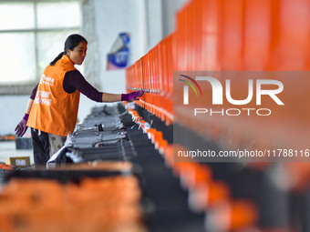 Workers sort parcels at an express logistics company in Qingzhou, China, on November 11, 2024. Monitoring data from the State Post Bureau sh...