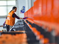 Workers sort parcels at an express logistics company in Qingzhou, China, on November 11, 2024. Monitoring data from the State Post Bureau sh...