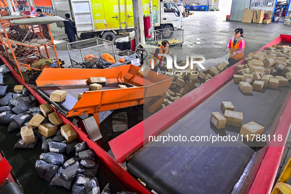 Workers sort parcels at an express logistics company in Qingzhou, China, on November 11, 2024. Monitoring data from the State Post Bureau sh...