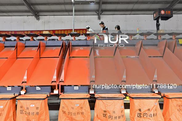 Workers sort parcels at an express logistics company in Qingzhou, China, on November 11, 2024. Monitoring data from the State Post Bureau sh...